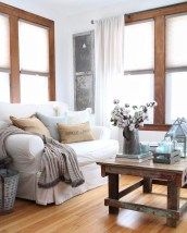 a living room with wooden floors and white couches in it's center area