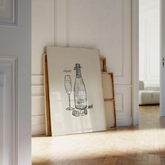 an art piece is displayed on the floor in front of a framed poster that says champagne