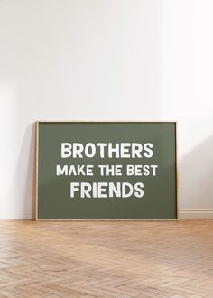 a black and white sign that says brothers make the best friends in front of a wooden floor