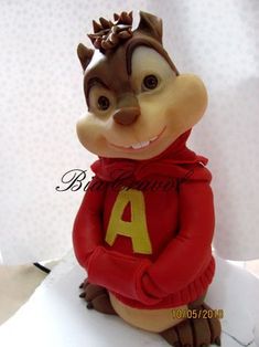 a figurine of a chipmun with a red shirt and yellow letters on it's chest