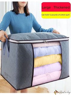 a woman is holding a large storage bag