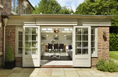 an open patio with sliding glass doors leading into the dining room