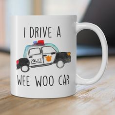 a white coffee mug that says i drive a wee woo car