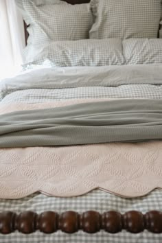 a bed with pillows and blankets on top of it