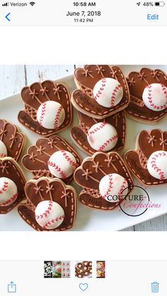 some heart shaped cookies with baseballs and hearts on them sitting on a white plate