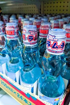 there are many bottles of water on the shelf