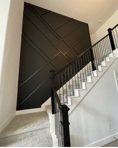 a staircase with black railings and white stairs