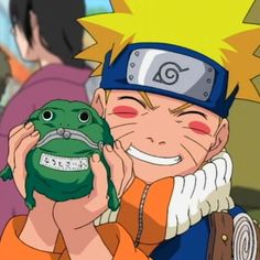 naruto holding a green frog in his hand