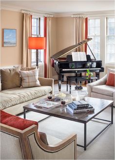 a living room filled with furniture and a piano