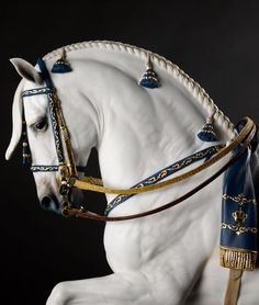 a statue of a white horse with blue and gold details