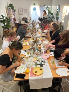 a group of people sitting around a table eating food