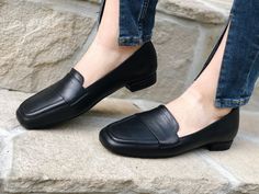 These sleek and timeless black leather loafers are a must-have for women who appreciate comfort and classic style. Handcrafted from genuine leather, they feature a modern square toe design, offering a sophisticated yet versatile look. The slip-on style ensures ease and convenience, making them perfect for daily wear, whether you're headed to the office, running errands, or enjoying a casual day out. The minimalist design is ideal for pairing with jeans, skirts, or professional attire, offering a Penny Loafers For Women, Satin Wedding Shoes, Womens Loafers, Black Flats Shoes, Loafer Shoes Women, Handmade Leather Shoes, Casual Footwear, Minimalist Shoes, Black Leather Flats