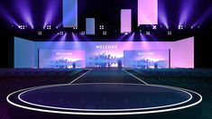 an empty stage set up for a show with bright lights and purple lighting on the walls