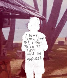 a person standing in front of a tree with writing on it that says i don't know how far i have to go to feel like i'm enough