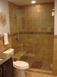 a bathroom with a walk in shower next to a toilet