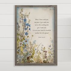 a painting on the wall with a verse written in blue and green flowers next to it