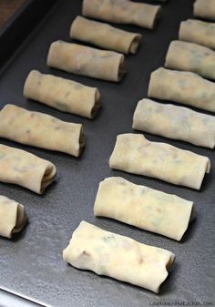 rolls are lined up on a baking sheet and ready to go into the oven or bake