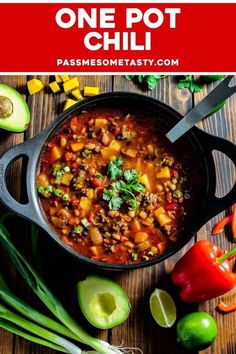 one pot chili with avocado, cilantro and limes on the side