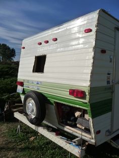 an rv parked on the back of a trailer