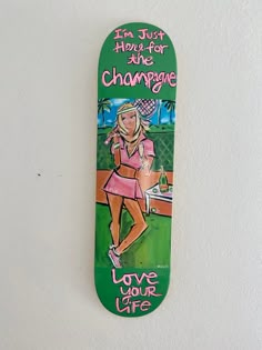 a skateboard with an image of a tennis player on it's bottom and the words i am just here for the champagne