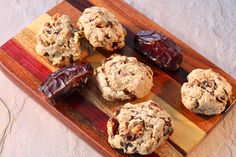 cookies and jelly on a cutting board with some dried fruit in the background to be eaten