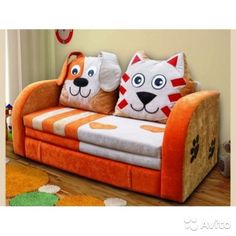 two stuffed animals sitting on top of an orange couch