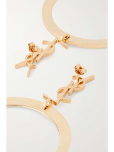 SAINT LAURENT Cassandre gold-tone earrings Saint Laurent Earrings, Luxury Gold-tone Classic Hoop Earrings, Yves Saint Laurent Earrings, Luxury Statement Hoop Earrings With Gold-tone Hardware, Luxury Gold-tone Brass Hoop Earrings, Gold Pearl Earrings, Single Earring, Tassel Earrings, Gold Tone Metal