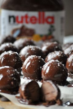 chocolate covered donuts on a plate with nutella in the background