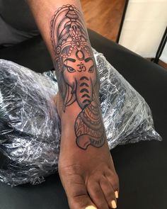 a person with a tattoo on their foot and an elephant in the middle of it