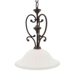 a light fixture with a white glass shade hanging from it's center point and an ornate design on the bottom