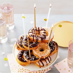 a plate with donuts and candles on it