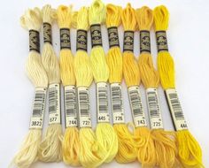 six skeins of yellow and white yarn