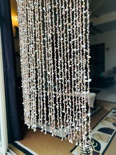 the beaded curtain is hanging from the ceiling