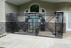 a gated entrance to a house that has snow on the ground