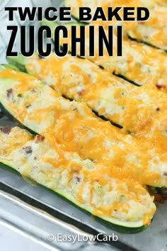 zucchini stuffed with cheese on a baking sheet