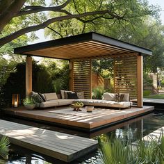 an outdoor living area with couches, tables and water feature in the middle of it