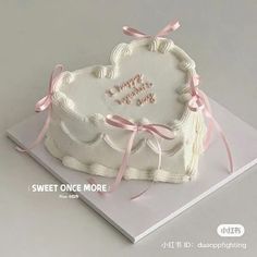 a heart shaped cake on top of a white plate with pink ribbon around it and the words sweet once more