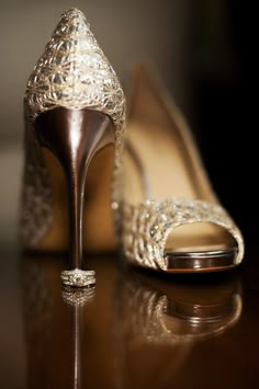 a pair of high heeled shoes sitting on top of a table