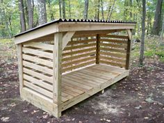 a small wooden shelter in the woods