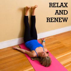 a woman is doing yoga on a pink mat with her legs up in the air