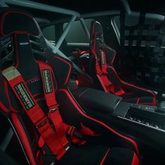 the interior of a car with red and black seats