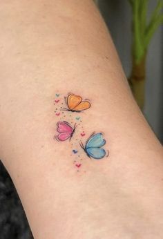 a woman's leg with three butterflies on the left side of her body and one is