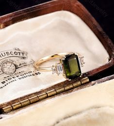 a green ring sitting on top of a wooden box