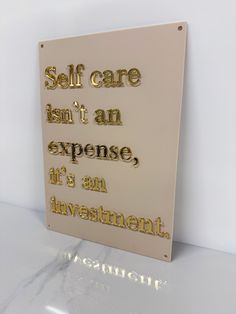 a sign that says self care isn't an expensive it's an investment