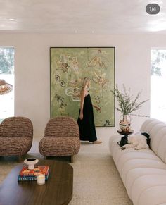 a woman standing in the middle of a living room