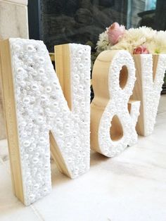 the letters are made out of beads and wood