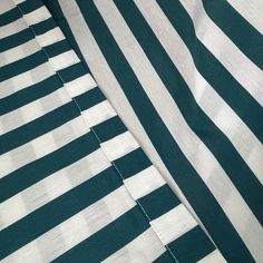 green and white striped fabric with stitching on it