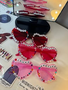 Hand decorated Jonas Brothers love heart glasses 💗 Colours available: Dark pink Purple Light pink Red Blue Yellow Arms of the glasses may be stiff when opening but they will fully open with care 💗MESSAGE ME FOR REQUESTS💗 If you would like any other lyrics, please message me before you purchase so I can confirm it will fit on the glasses.  All glasses are hand decorated so will be slightly different than the photos.  *design subject to change at anytime - no two glasses will be the same* If yo Heart Glasses Decorated, Decorated Heart Glasses, Diy Heart Glasses, Festival Glasses, Bedazzled Glasses, Decorated Glasses, Heart Glasses With Beads, Sweet Sixteen Party Themes, Beaded Sunglasses