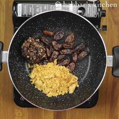 some food is cooking in a frying pan on the stove top and ready to be cooked