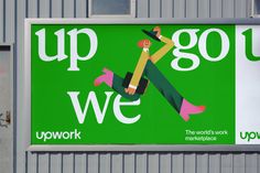 a large sign on the side of a building that says up and go we work